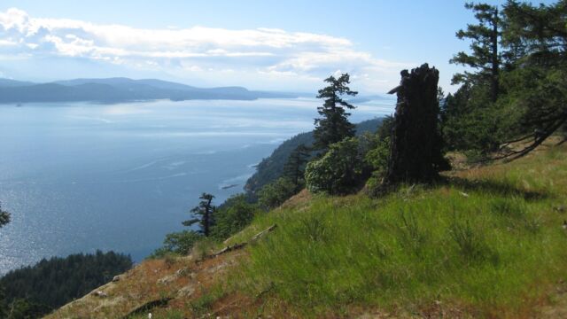 View looking northwest. Visible in the Trincomali Channel below: Parker and Julia Island (the latter barely visible) and Phillimore Point
